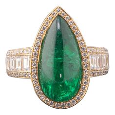 Perfectly designed cocktail ring with a gorgeous pear shape cabochon Zambian Emerald center stone. The stone has great luster and color with very few naturally occurring inclusions with colorless, VVS quality Emerald cut and Round diamonds on the band - all set in solid 18K Yellow Gold. Currently US size 6, can be altered. Please feel free to message us for any queries/extra photos and videos! We accept returns, and we provide free shipping! Stone Details: Stone: Zambian Emerald Cut: Pear Caboch Engagement Ring Art Deco, Zambian Emerald, Right Hand Rings, Ring Art Deco, Art Deco Engagement Ring, Pretty Rings, Zambia, Inspiration Art, Emerald Ring