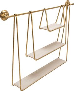 two gold metal shelves with white shelves on each side and one shelf attached to the wall