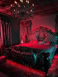 an ornate bed with red lights in a dark room, and chandelier hanging from the ceiling