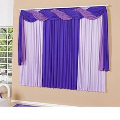 purple and white curtains are hanging on the wall