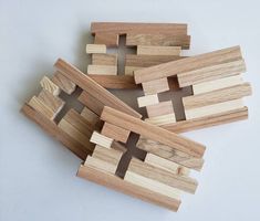 four pieces of wood that have been made to look like crosses and are laying on top of each other