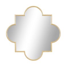 a gold and white mirror with an ornate design on the bottom, against a white background