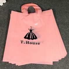 a pink shopping bag sitting on the floor