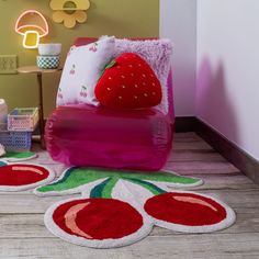 a child's bedroom decorated in pink and green with strawberry rugs on the floor