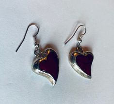 "This is a pair of heart-shaped sterling silver (.925) red dangle/drop earrings. Material(s): Sterling Silver (.925) + red stone (the photos make the heart appear black, but they are a dark red) Total weight: 6.2 grams Flaws (if any): None to mention Marking(s): \".925\" (translating to \"sterling silver\") Measurements: The drop length of these earrings is 1 and 3/8 inches. The width of these earrings is 3/4 of an inch, at their widest point. If you have any questions about this pair of earring Vintage Double Heart Earrings As Gift, Vintage Double Heart Earrings For Gift, Red Polished Earrings For Gift, Valentine's Day Gift Earrings With Polished Finish, Red Sterling Silver Dangle Heart Earrings, Red Sterling Silver Pierced Heart Earrings, Handmade Red Heart Earrings In Sterling Silver, Handmade Red Heart Sterling Silver Earrings, Silver Vintage Heart Earrings For Valentine's Day