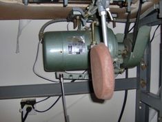 an industrial machine is being worked on in a factory or repair area with wires and other equipment