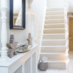 a white staircase decorated with christmas lights and decorations