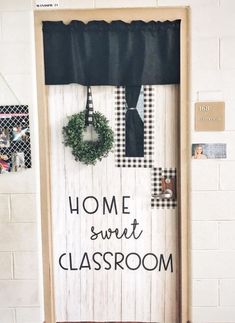 a classroom door decorated with black and white checkered curtains, wreaths and the words home sweet classroom