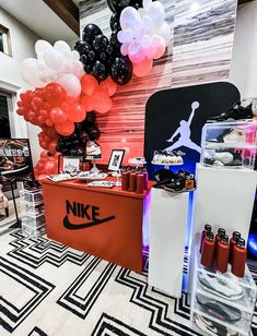 the nike store is decorated with red, white and black balloons