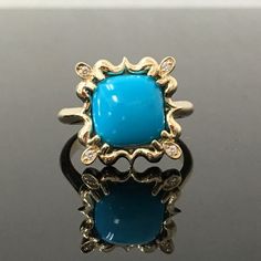 "14K Yellow Gold Turquoise and Diamond Ring METAL: 14K Yellow Gold TOTAL WEIGHT: 7.5 g TURQUOISE: Cushion Cabochon AAA Sleeping Beauty Turquoise Mined in Arizona 10 mm x 10 mm DIAMONDS: 4 Round Brilliant Cut Diamonds COLOR: H CLARITY: VS2 TOTAL WEIGHT: 0.04 SIZE: Ladies size 4-12. Please indicate your ring size at checkout. DESCRIPTION: This original design features an 10mm x 10mm Sleeping Beauty Turquoise. It has a sunburst design surrounding it, with a diamond set in each corner of the \"halo\ Luxury Turquoise 14k Gold Ring, Luxury Yellow Gold Turquoise Ring With Gemstone Accents, Hallmarked Turquoise Ring Fine Jewelry, Hallmarked Turquoise Fine Jewelry Ring, Turquoise Multi-stone 14k Gold Jewelry, Elegant Yellow Gold Turquoise Ring With Gemstone Accents, 14k Gold Multi-stone Turquoise Jewelry, Luxury Yellow Gold Turquoise Cabochon Ring, Elegant Yellow Gold Multi-stone Turquoise Ring