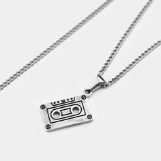 CASSETTE IN SILVER PLATED / 18K GOLD PLATED STAINLESS STEEL Water/sweat/heat resistant (no green skin) Includes: 50cm long micro cuban chain + 20mm x 10mm pendant We make our chains + pendants following our sustainable ethos. Up to 60% of the stainless steel we use has been recycled from other sources, and it can be fully recycled again to make new products in the future. Cuban Link Box Chain Necklace For Streetwear, Streetwear Necklaces With Cuban Link Box Chain, Streetwear Necklaces With Box Chain And Cuban Link, Streetwear Pendant Necklace With Chain, Music Pendant Necklace, Music-themed Pendant Necklace As Gift, Silver Music-themed Metal Necklace, Tarot Card Necklace Silver, Music-themed Silver Pendant Necklace