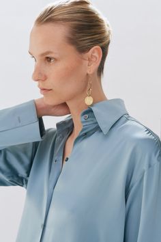 Our Ice Blue Silk oversized tailored shirt is made of 100% Silk. The shirt features a traditional collar, button stand with mother of pearl buttons and oversized cuffs with our signature button detail. Brown Silk, French Seam, Blue Silk, Mother Of Pearl Buttons, Pearl Buttons, Poplin Shirt, Navy Stripes, Silk Shirt, Button Detail