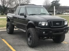 a black pickup truck parked in a parking lot