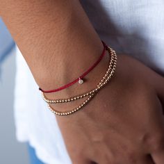 Our gold bead bracelets are available in 14K gold and rose gold. Handcrafted using perfectly round 2.5mm gold beads strung together on an elastic band, this dainty minimalist bracelet is easy to put on and remove. It's the perfect stacking bracelet but looks just as lovely all on its own. Available in three sizes, you're sure to find the perfect fit! Details: 2.5mm round beads Elastic closure The additional diamond charm bracelet shown in the photo can be purchased here: https://www.etsy.com/lis Rose Gold Beaded Bracelet, Dainty Accessories, Gold Bead Bracelet, Silk Bracelet, Red String Bracelet, Stacking Bracelets, Rose Gold Beads, Gold Bead Necklace, Ball Bracelet