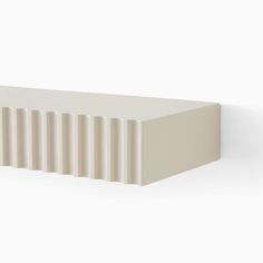 a white rectangular object is shown against a white background, with vertical stripes on the edges