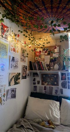 a bed with lots of pictures on the wall and lights hanging from it's ceiling