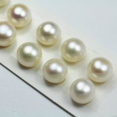 six white pearls sitting on top of a piece of paper