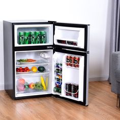 an open refrigerator filled with lots of different types of foods and drinks on top of it