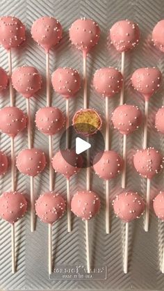 pink cake pops with white sprinkles arranged on a silver platter for a video