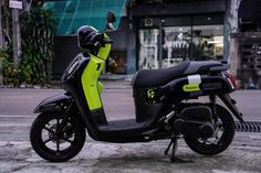 a black and yellow scooter parked on the street