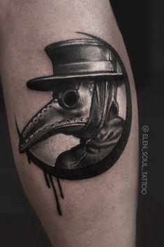 a black and white tattoo with a bird wearing a hat