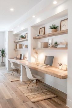 a home office with white walls and wooden floors, built in shelving units on either side of the desk