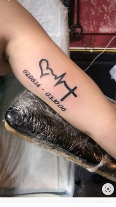 a person with a tattoo on their arm that says, i love you and the cross is