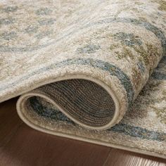 an area rug is laying on the floor with it's end rolled up to look like a carpet