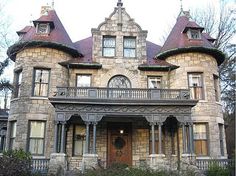 an old victorian style house with two towers