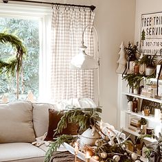 a living room filled with furniture and christmas decorations