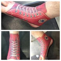 the foot is painted red and has white laces on it's toes, with an image of a shoe in the middle