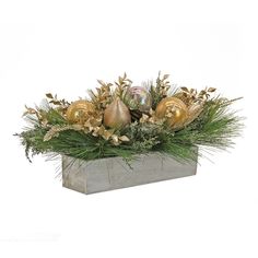 a planter filled with gold ornaments and greenery