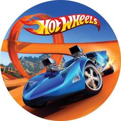 a blue car driving down a road next to a sign that says, hot wheels