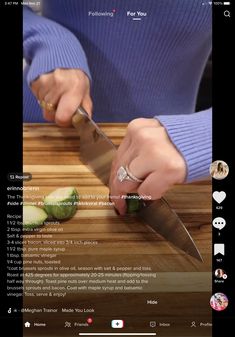 someone is cutting up some food on a wooden table with a knife and chopping board