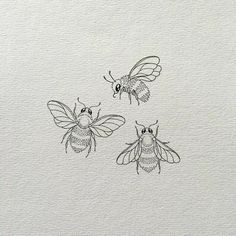 three bees flying in the air on top of a white paper sheet with black ink