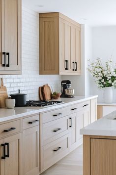 a kitchen with wooden cabinets and white counter tops