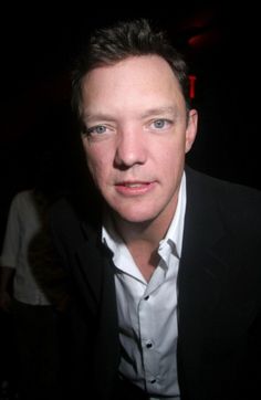 a man in a black suit and white shirt