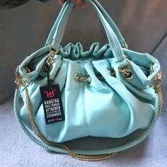 This Beautiful Mint Color Bag Is Perfect For Summer! The Bag Features Beautiful Gold Hardware And Large Gold Studds Down Both Sides Of The Bag. Large Interor With Zipper Pocket And Two Open Pockets. Beautiful Satin Like Fabric On The Inside. Plenty Of Room For All Your Essentials. One Large Gold Chain And One Braided Strap Affixed To The Bag For Optional Shoulder Use. A Beautiful Bag! Nwt 18 1/2"W X 17" H (From Top Of The Handle To The Bottom) Nwt *Gorgeous Mint Green Bag* Smoke Free & Clean Hom Mint Green Bag, Mint Green Bags, Mint Green Purse, Green Purse, Braided Strap, Mint Color, Green Bag, Beautiful Bags, Gold Hardware