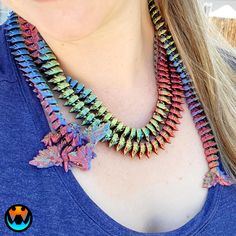 a woman wearing a multicolored necklace with leaves on the front and back of her neck