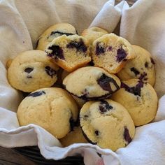 a basket filled with blueberry muffins on top of a table