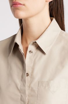 A cropped silhouette balanced by a slightly boxy fit enhances the breezy look of this button-up shirt cut from smooth poplin. Hidden-button placket Point collar Long sleeves with button cuffs Chest patch pocket 53% cotton, 47% polyester Dry clean Imported Classic Cropped Button-up Shirt With Button Cuffs, Classic Short Sleeve Cropped Shirt For Work, Classic Cropped Short Sleeve Shirt For Work, Classic Cropped Shirt For Summer Workwear, Modern Collared Cropped Shirt For Work, Elegant Button-up Cropped Shirt For Work, Classic Collared Cropped Shirt For Office, Elegant Cropped Shirt With Button Closure For Work, Classic Cropped Shirt For Daywear