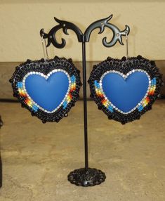 Heart shaped beaded earrings. super sparkly, super pretty  Made with a blue matte heart center,black, gold, and fire color seed beads. on short kidney hooks.  Perfect for VALENTINE'S DAY These detailed handmade beaded earrings are a stunning jewelry piece with their own unique style. Wear them anytime and anywhere!!  Each seed bead is physically woven with beading thread onto a stiffened felt stabilizer.Rhinestone cup chain banding is added, for extra texture and sparkle. Faux leather backing is glued and stitched on to the back of each earring then the edges are stitched with seed beads and bicones. Lots of time and patience goes into making each earring.  I appreciate you taking the time to look at my beadwork Thank you!! Blue Handmade Heart Drop Earrings, Handmade Blue Heart Drop Earrings, Adjustable Beaded Heart Earrings As Gift, Handmade Blue Heart-shaped Beaded Earrings, Handmade Heart-shaped Beaded Earrings, Blue Heart Bead Earrings, Blue Dangle Heart Earrings With Heart Beads, Blue Heart-shaped Earrings With Heart Beads, Adjustable Heart-shaped Beaded Earrings