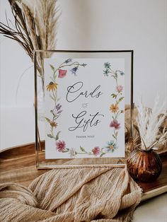 there is a sign that says ends and gifts on it next to some dried flowers