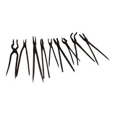 seven pairs of scissors are lined up in a row on a white background, with one being used as a tool