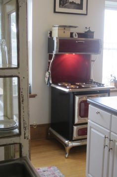 an old fashioned stove in the corner of a kitchen