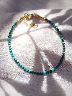 "A dainty jewelry design for appeasing the star within, this adjustable gold-filled bracelet comes beaded with tiny beads carved from all natural turquoise gemstone. ✦ DETAILS ✦ ✧ Name: Kalilinoe (kah lee lee noh eh) - rain. ✧ Adjustable Length from: 6.5\"-8\". ✧ Genuine 2.5mm faceted tiny Turquoise Beads. ✧ 14kt Gold Filled Components, Extender, and Clasp. ✧ All Ke Aloha Jewelry pieces come packaged thoughtfully, beautifully, and ready for gift giving. ✦ MORE GOLD BRACELETS ➤ https://www.etsy.c Hawaii Jewelry, Tiny Beads, Turquoise Bead Bracelet, Dainty Bracelets, Layered Bracelets, Natural Turquoise, Dainty Jewelry, Turquoise Gemstone, Turquoise Beads