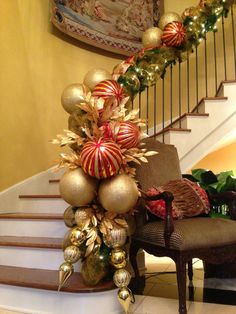 christmas decorations on top of a chair next to stairs