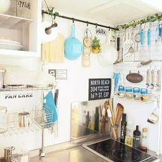 a kitchen with pots and pans hanging on the wall next to a stove top oven