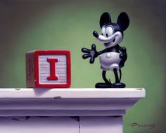 a mickey mouse figurine standing on top of a desk