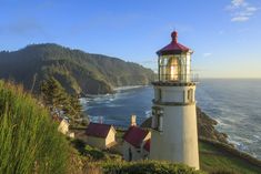 a light house sitting on top of a cliff next to the ocean